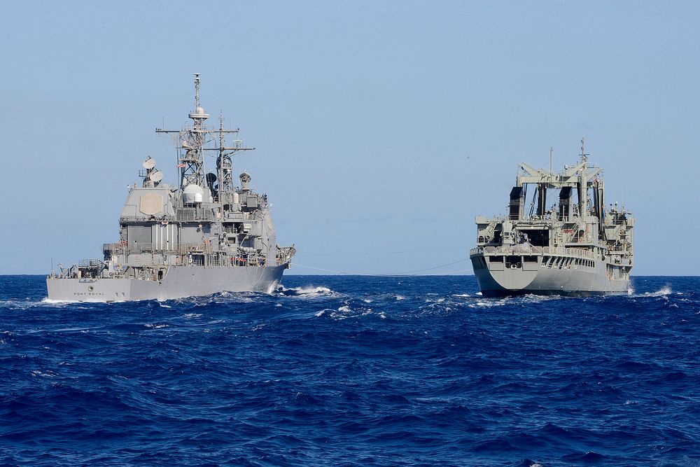 The guided missile cruiser USS Port Royal (CG 73), left, prepares to refuel at sea with the Royal Australian Navy…