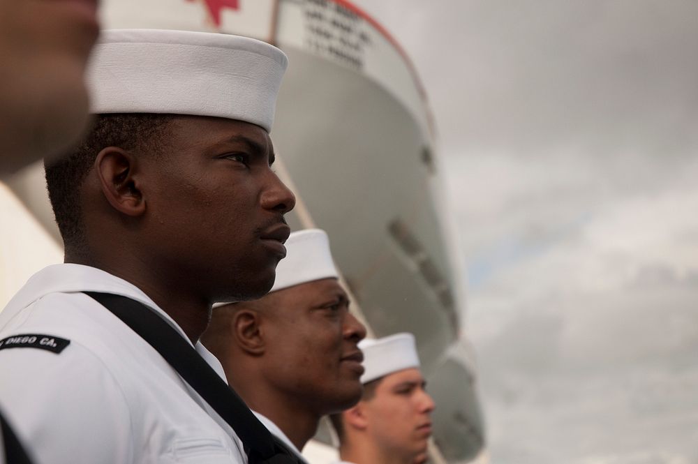 Sailors standing in front of the ship. Original public domain image from Flickr