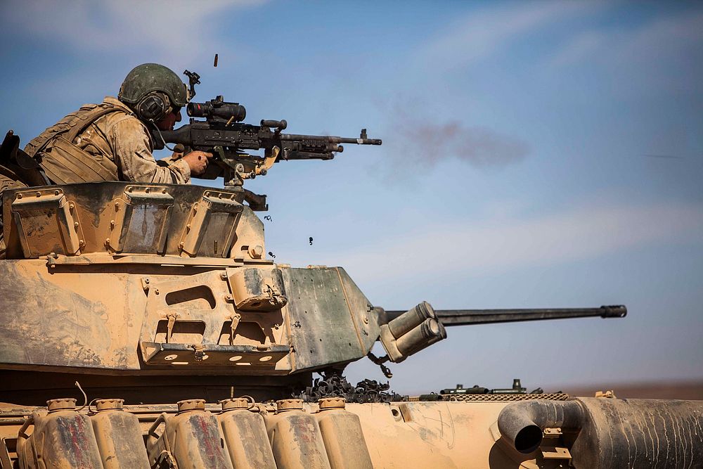 A U.S. Marine with Battalion Landing Team, 1st Battalion, 6th Marine Regiment, 22nd Marine Expeditionary Unit (MEU) shoots…