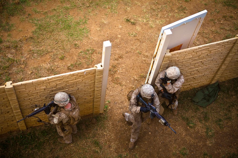Cleared!U.S. Marines assigned to India Company, 3D Battalion, 3D Marine Regiment, enter a compound gate during a search and…