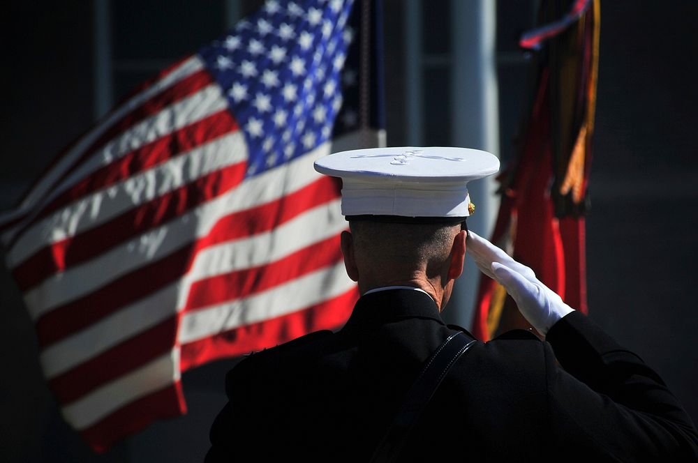 U.S. Marine Corps Gen. James F. Amos, the outgoing commandant of the Marine Corps, salutes the colors during the passage of…