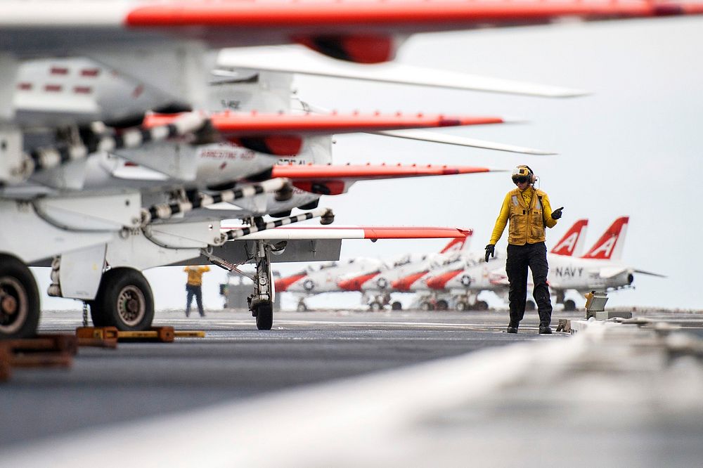 U.S. Navy Aviation Boatswain's Mate (Handling) 2nd Class Christopher O'Neil directs T-45C Goshawk aircraft assigned to…