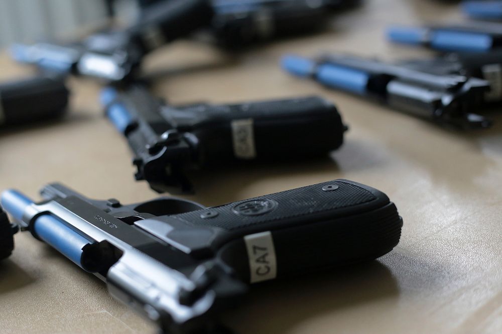 Beretta M9 semi automatic pistols modded with Simunition parts sit on a table prior to training use at Atlantic Cape…