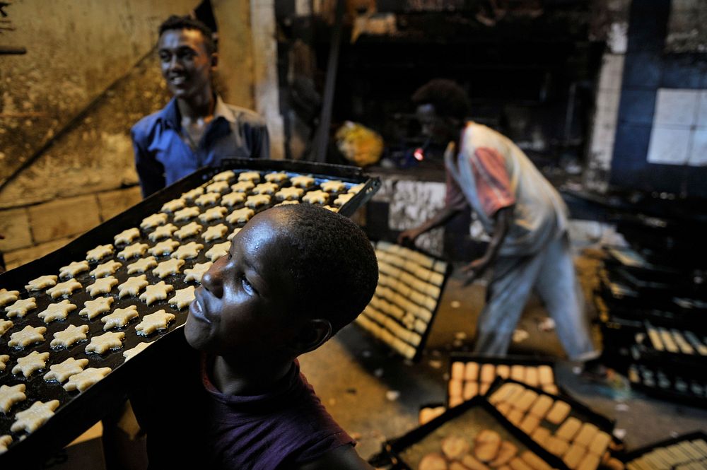 Bakers prepare biscuits ahead of Eid al-Adha in the Hamar Weyne district of Mogadishu, Somalia, on October 3. AMISOM Photo /…