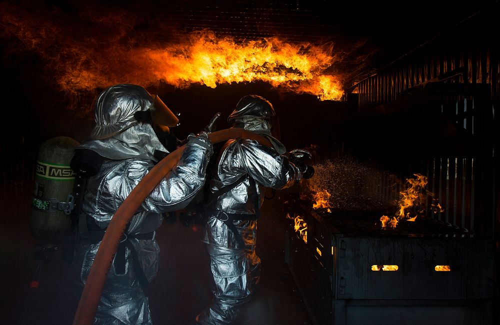 U.S. Air Force firefighters fight flames during a controlled building fire exercise at Ramstein Air Base, Germany on Mar.…