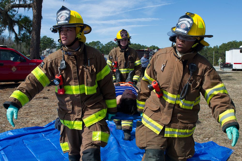 City of Georgetown firefighters carry a simulated victim to be triaged during the Vigilant Guard South Carolina exercise, in…
