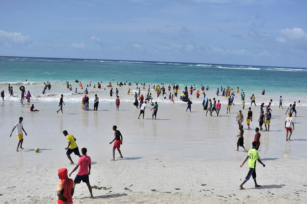 Residents of Mogadishu, Somalia, enjoy the waters off of Lido beach during their holiday. Original public domain image from…