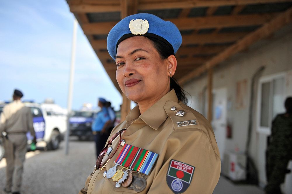 A Police officer from Bangladesh, serving under the United Nations Police attends a ceremony during which a total of 56…