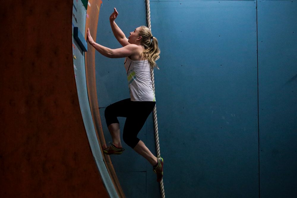 Kim Wienches reaches for the top of the Curved Wall at Pinnacle Parkour Academy on Aug. 26. Original public domain image…