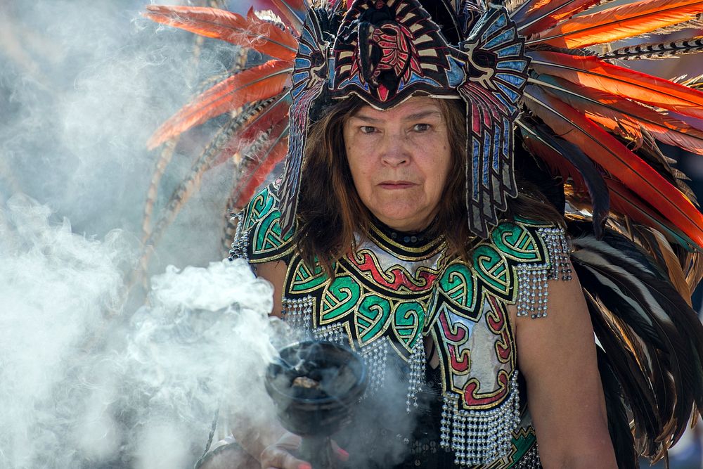 An Aztec healer holds a cauldron of cleansing smoke during a dance performance at the annual Latino Heritage Festival in Des…