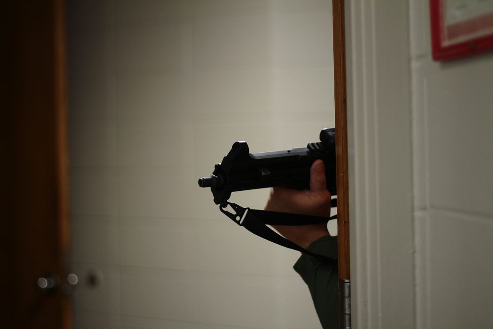 An Atlantic County SWAT member peers around a corner at Atlantic Cape Community College in Hamilton Township, N.J. Members…