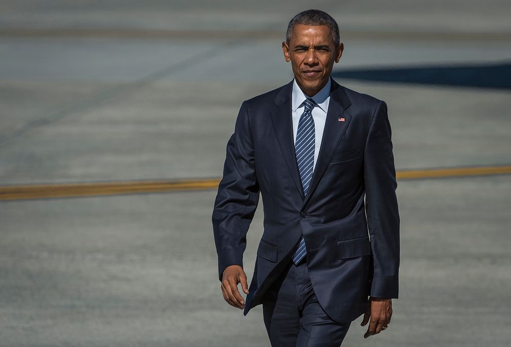 President Barack Obama walks toward a crowd after disembarking Air Force One at Joint Base Elmendorf-Richardson, Alaska…