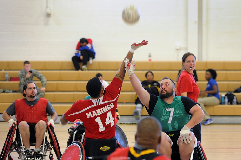 USMC Wounded Warrior Cpl. Jorge Salazar and Army Wounded Warrior, execute “Tip-off” to begin tournament play.