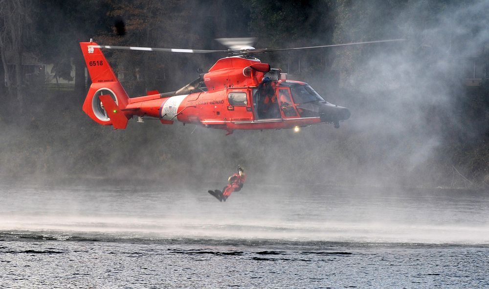 A U.S. Coast Guardsmen drops into waters during extraction training as part of Disaster Management Exchange 2015 at Joint…