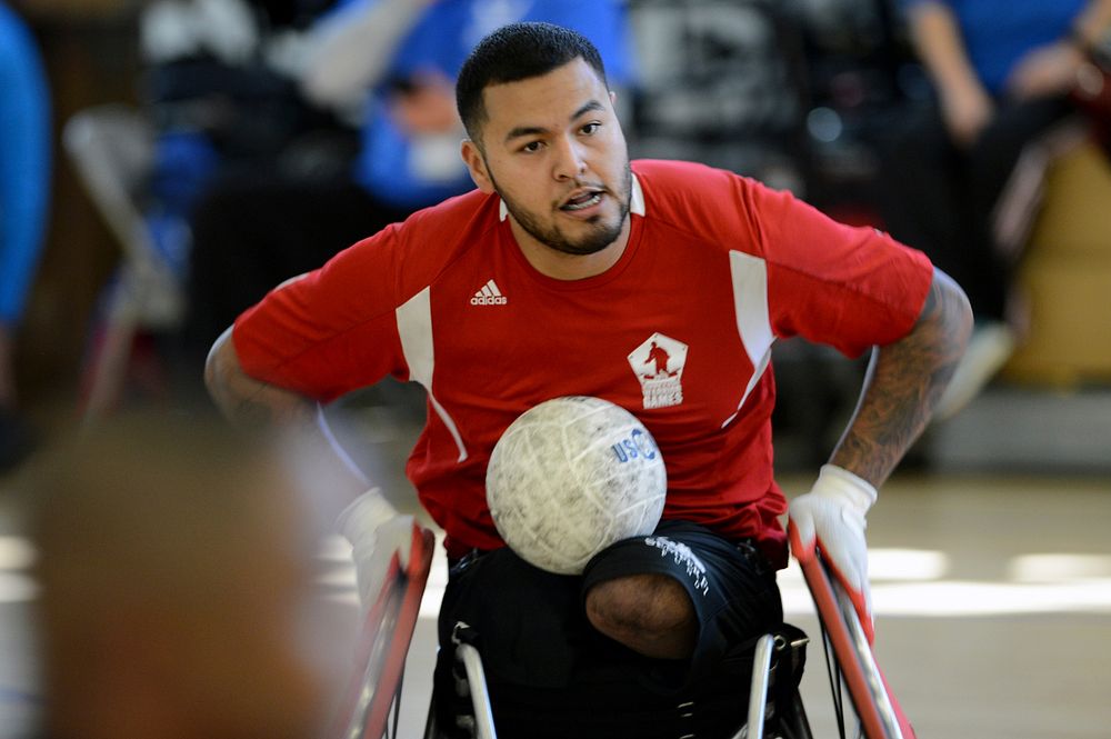USMC Wounded Warrior, Cpl. Jorge Salazar advances the ball up-court during tournament play.