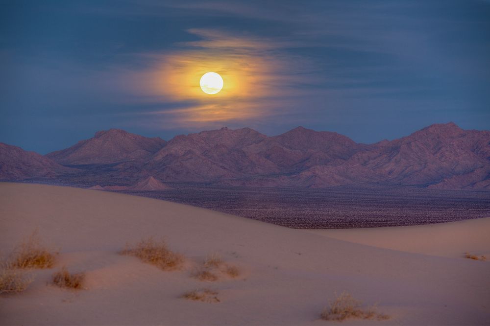 Desert with mountain range during moonrise at dawn. Original public domain image from Flickr