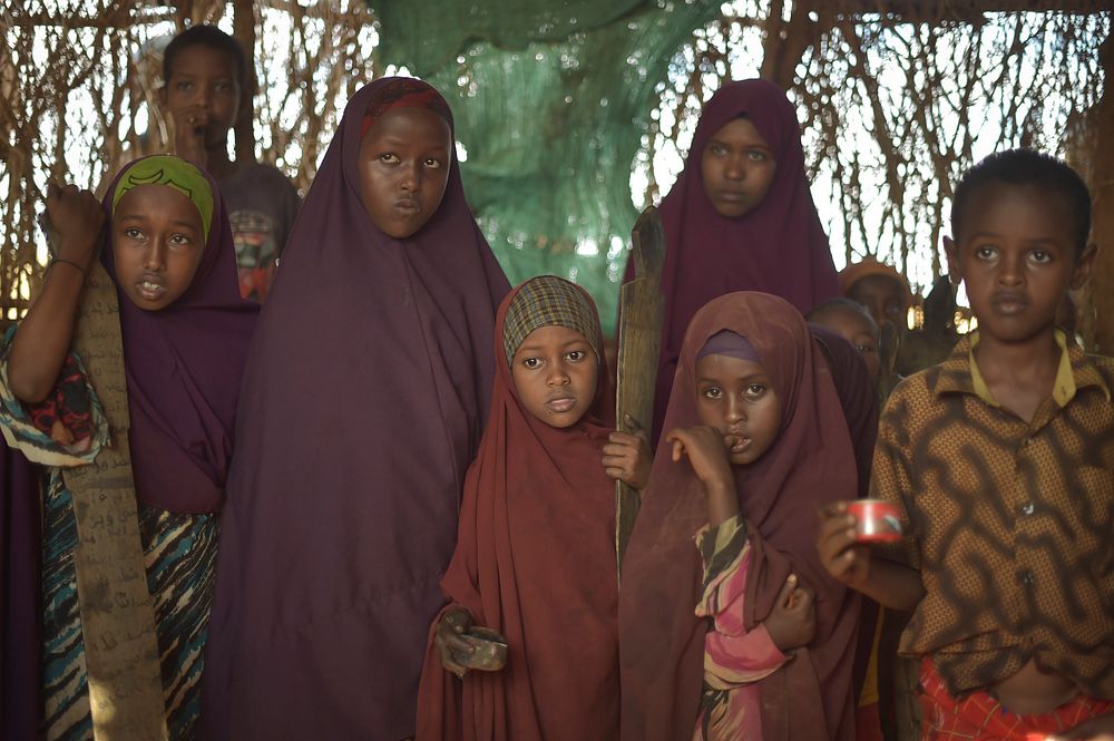 Young children stand with their writing tablets at a madrasa in Biyo Adde, Somalia, on March 7. The town of Biyo Adde was…