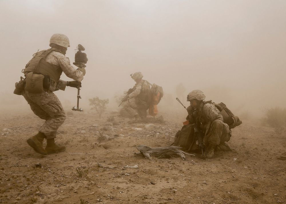 U.S. Marine Corps Sgt. Daniel D. Kujanpaa, left, a combat camera videographer with Marine Aviation Weapons and Tactics…