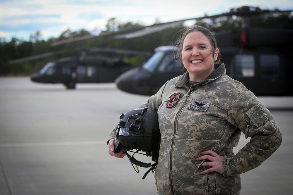 U.S. Army National Guard Chief Warrant Officer 3 Kristina Sofchak stands for a portrait in front of a UH-60L Black Hawk…