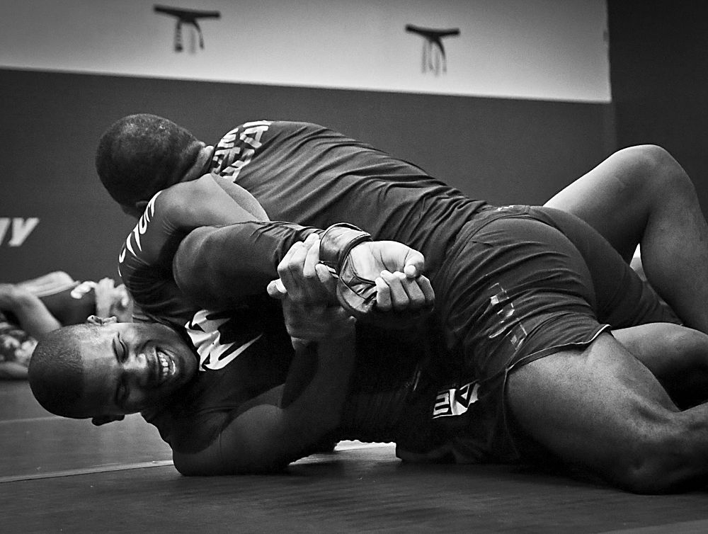 U.S. Air Force Staff Sgt. Leon Jackson, below, grapples and puts Ultimate Fighting Champion fighter Corey Anderson into an…