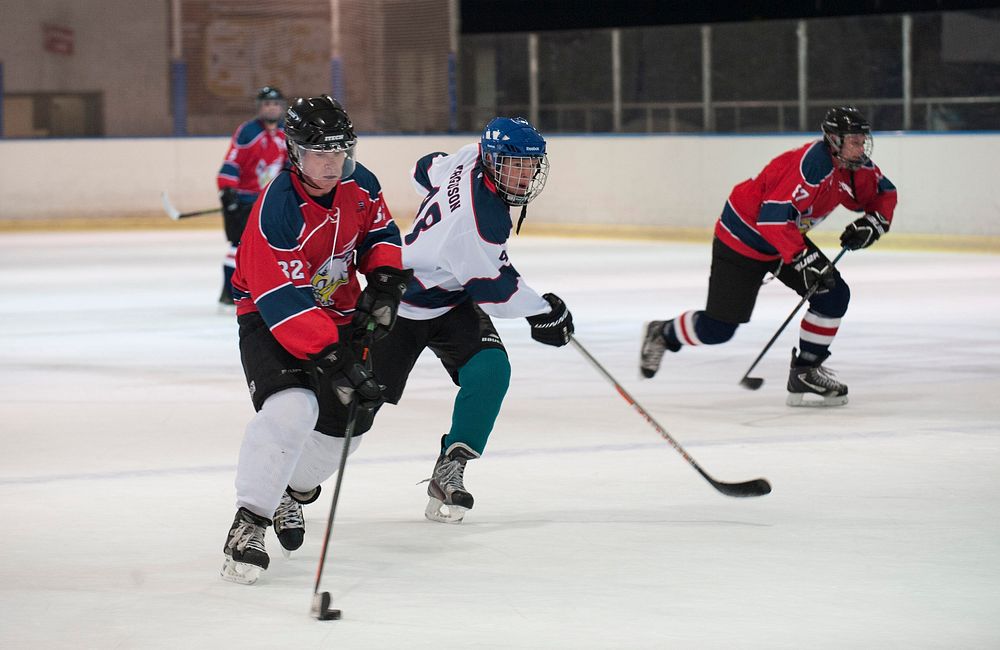 James Lee (left), a member of the Kaiserslautern Military Community Eagles Hockey Team, competes against another teammate…