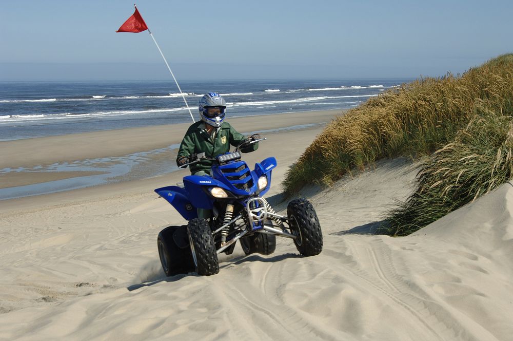 Woman Field Ranger riding Dune Buggy at Oregon Dunes, Siuslaw National Forest. Original public domain image from Flickr