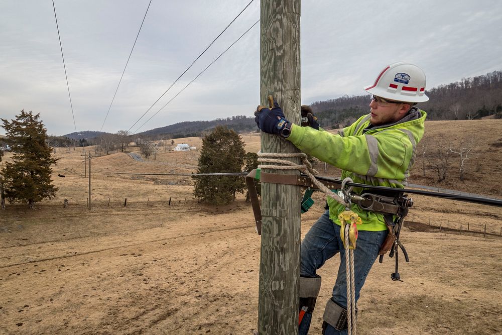 Contract Lineman Brandon Sims climbed utility pole to frame for future stand wire as Virginia's BARC Electric Cooperative…