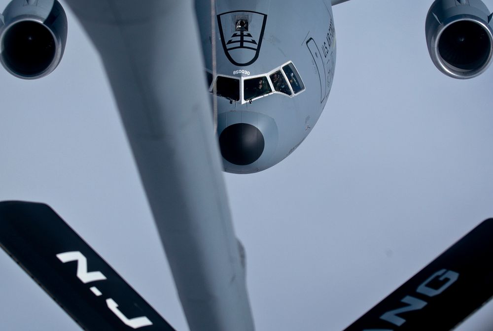 A U.S. Air Force KC-10 Extender from the 305th Air Mobility Wing flies over the Atlantic Ocean during an aerial refueling…