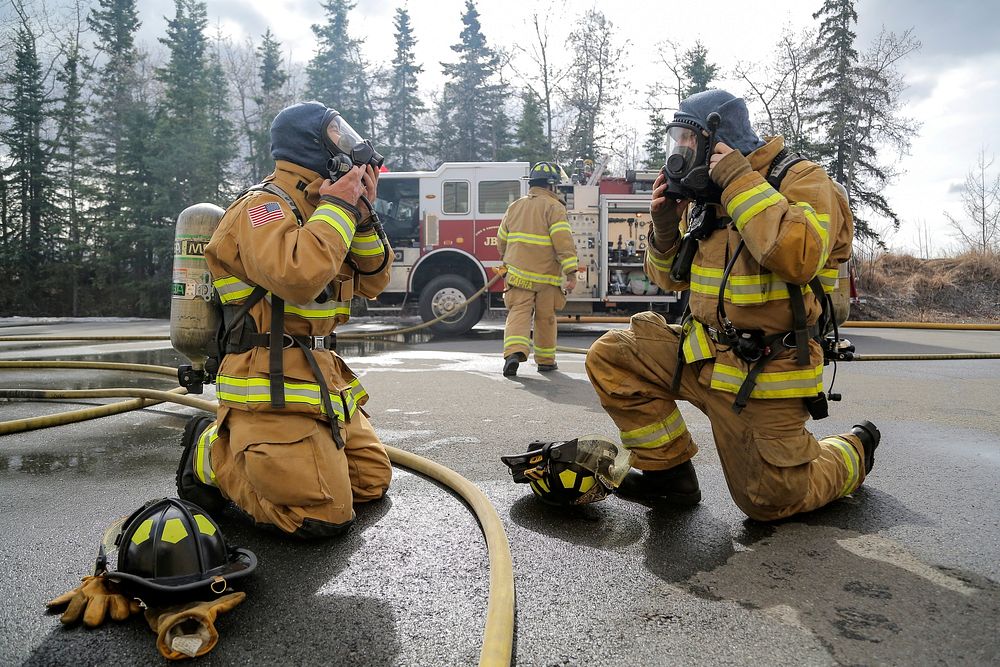 U.S. Air Force fire protection specialists, assigned to the 673rd Civil Engineer Squadron, don protective gear while…