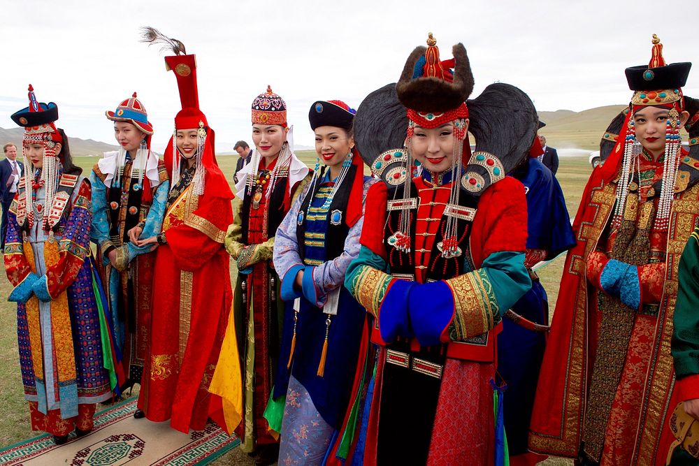 Men and Women in Traditional Mongolian Dress Look on as Secretary Kerry Attends a "Mini-Nadaam" at a Field Outside of…