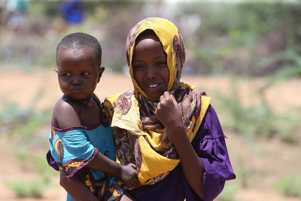 At the Dadaab refugee complex in north-eastern Kenya, a refugee girl and her sibling standing on a roadside path on 12 April…