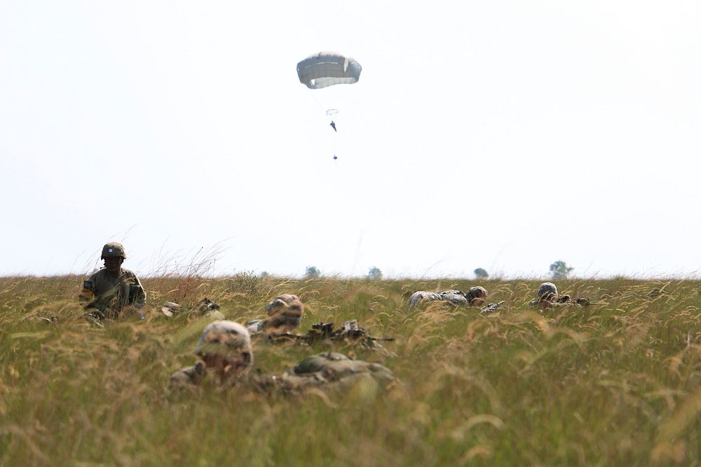 U.S. Army paratroopers with the 82nd Airborne Division provide security after jumping onto Point Denis drop zone in Gabon…