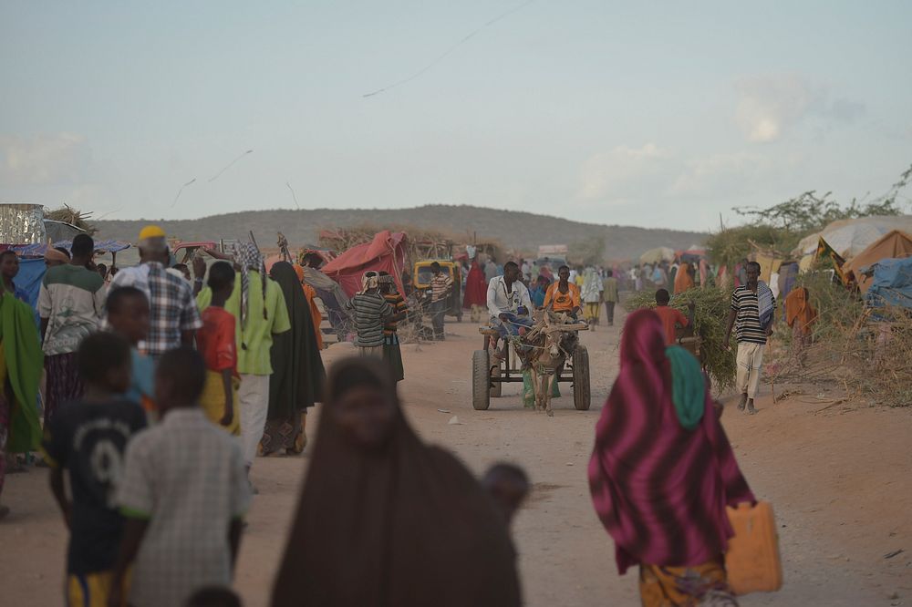 People walk through an IDP camp near the town of Beletweyne, Somalia, on May 28, 2016.