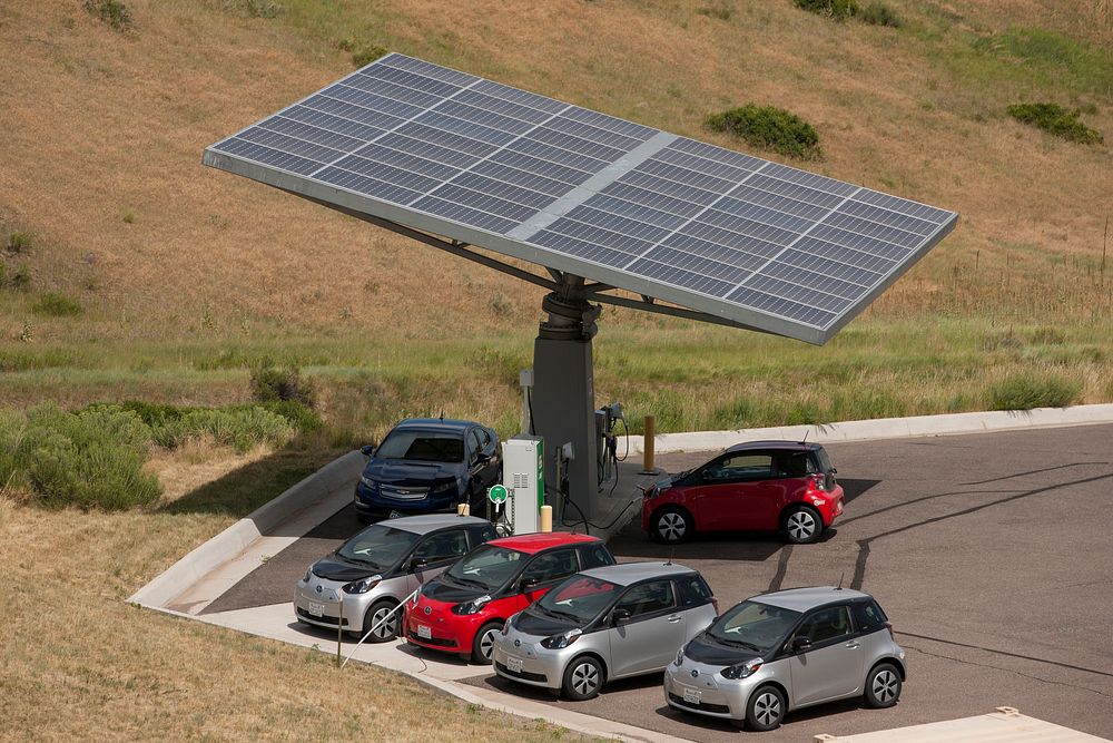 NREL,-owned electric vehicles (EVs) below solar canopy at the Vehicle Testing & integration Facility (VTIF), where vehicles…