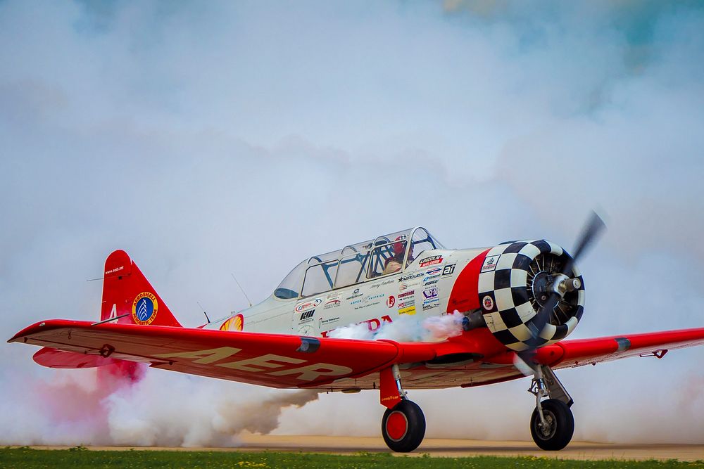 The Aeroshell Aerobatic Team (T-6 Texans) prepare for take off at the EAA AirVenture Oshkosh, Wisconsin.USDA Photo by…