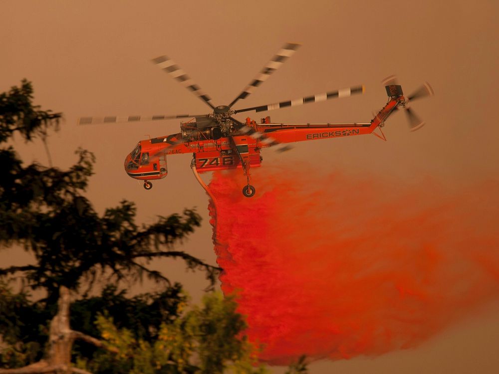 Heavy helicopter drops fire retardant on the Happy Camp Complex Fire in the Klamath National Forest in California, which…