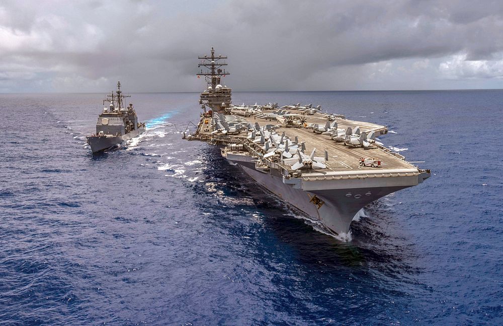 The guided-missile cruiser USS Antietam (CG 54) pulls alongside the Navy's forward-deployed aircraft carrier USS Ronald…