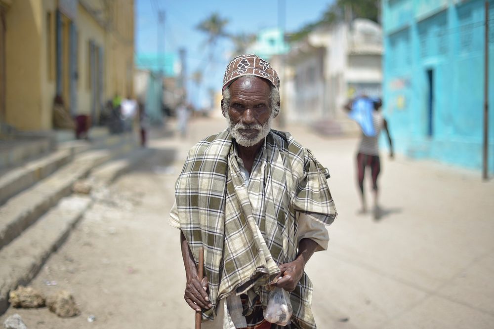 An elderly man stands on the street of Barawe, Somalia, on August 23, 2016.