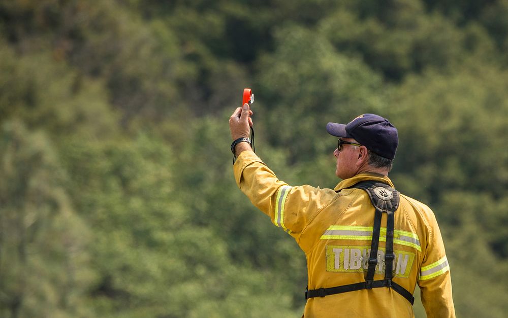 A wildland firefighter measures wind speed in the U.S. Department of Agriculture (USDA Forest Service (FS) Sequoia National…