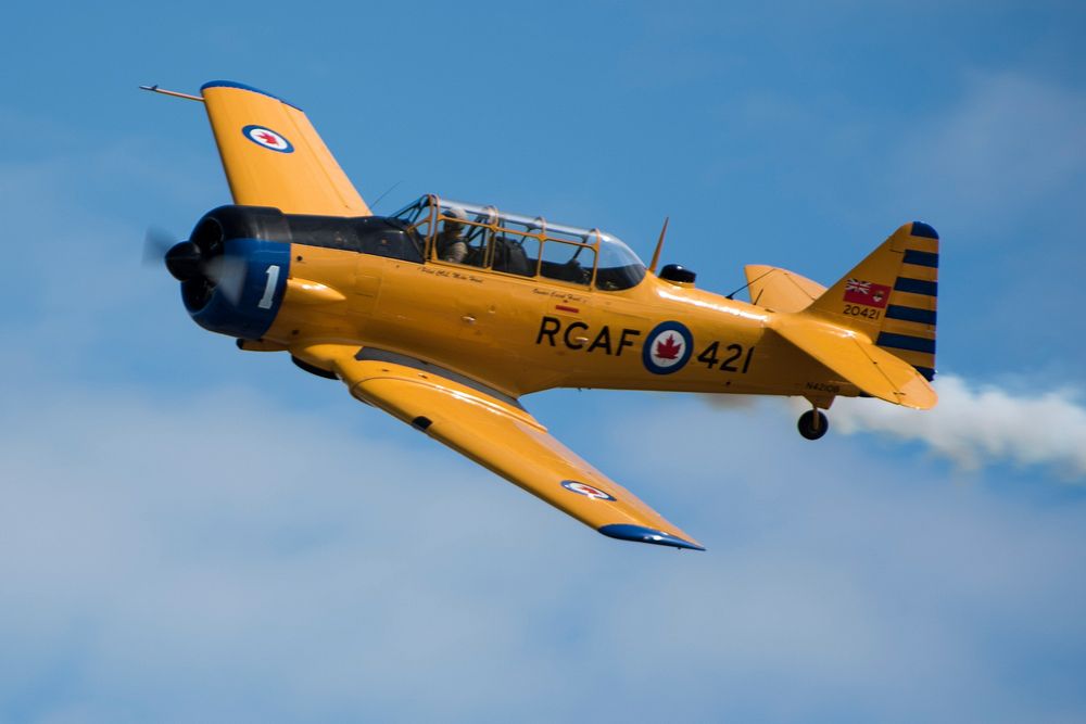 An AT-6 Harvard Mk IV performs an aerial display during the Heritage Flight demonstration at the Arctic Thunder Open House…