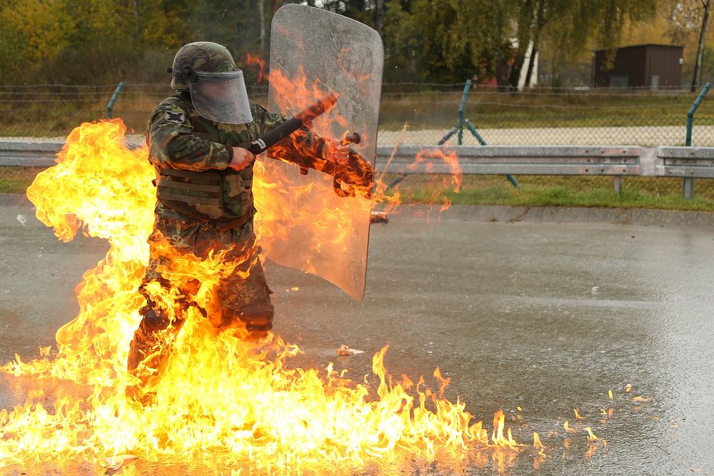 An Albanian soldier of 3rd Infantry Company, 2nd Infantry Battalion extinguishes flames from a molotov cocktail while…