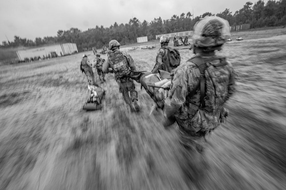 New Jersey Army National Guard combat medics move simulated casualties during a tactical trauma care course. Original public…