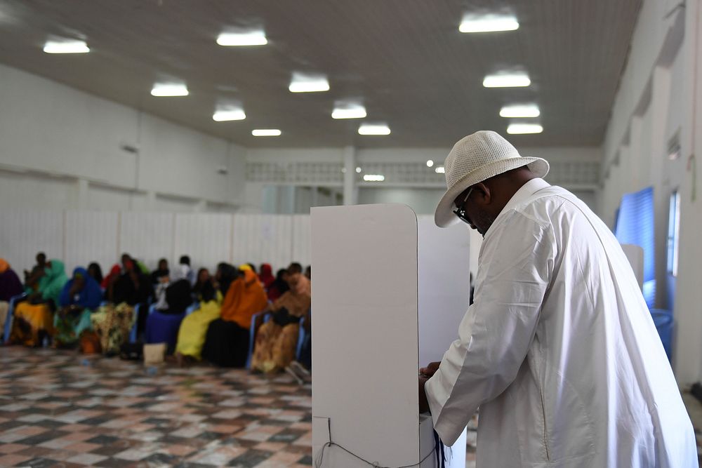 A delegate fills his ballot in a voting booth during Somaliland's ongoing electoral process in Mogadishu, Somalia, on…