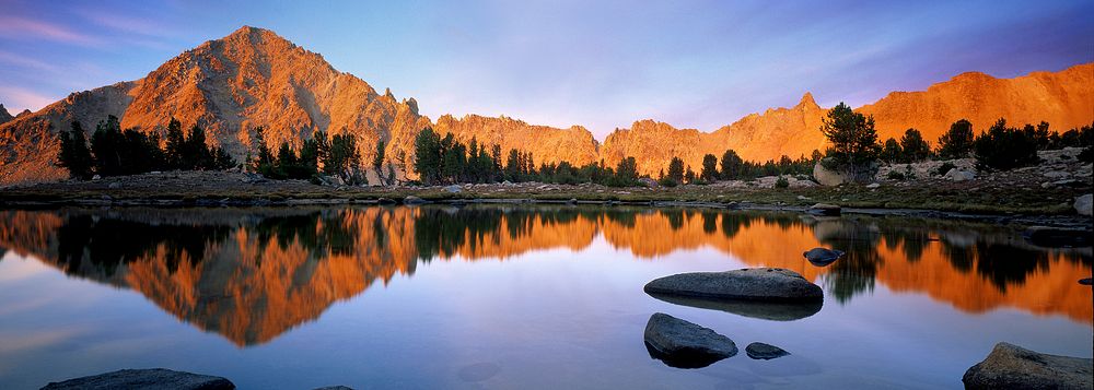White Cloud peaks reflect into a small lake on the Windy Devil Pass in the Sawtooth National Forest. Original public domain…