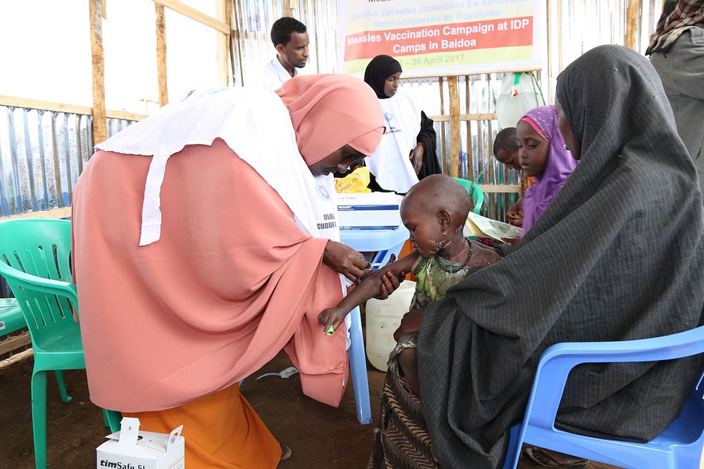 A child receives a measles vaccine at the launch of a UNICEF-supported immunization campaign at the Beerta Muuri camp for…