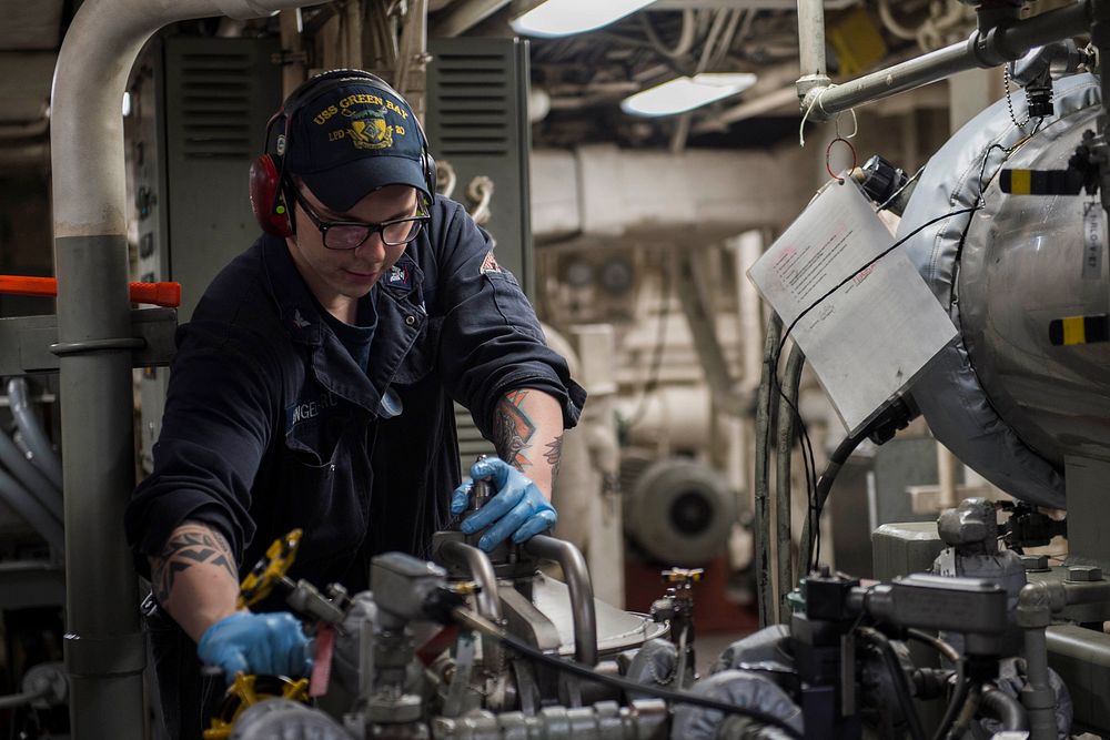 U.S.Navy Engineman 3rd Class Scotty Engelhard, from Lake St. Louis, Mo., works on a lube oil purifier in the main machinery…