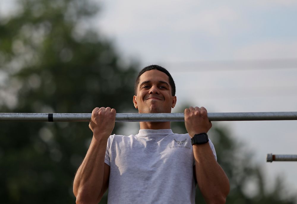 A U.S. Air Force airman from the New Jersey Air National Guard's 108th Wing does the flex arm hang during a German Armed…