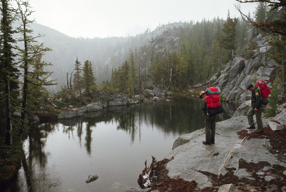 Hikers at lake in lower Enchantments, Alpine Lakes Wilderness, Wenatchee Nat'l Forest 1968. Original public domain image…