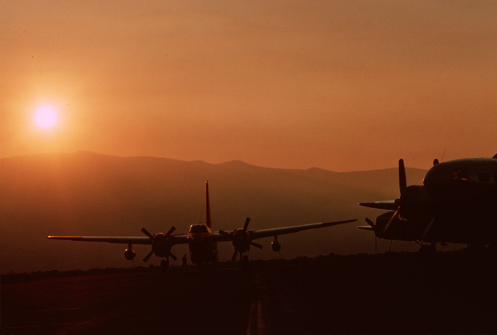 Wenatchee Pangborn field tankers as sun rises through smoke. Original public domain image from Flickr