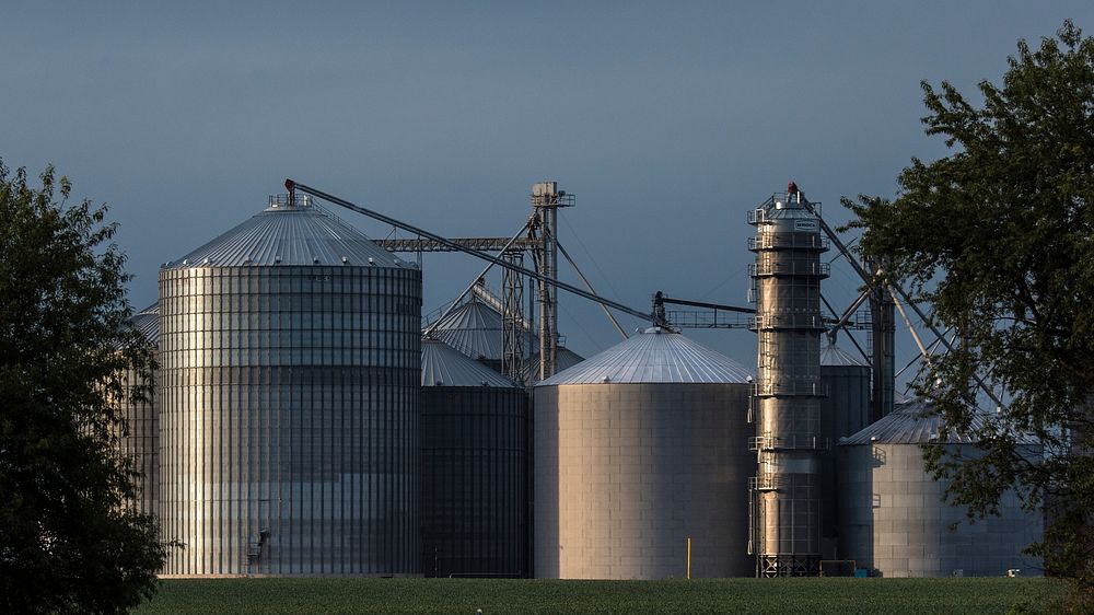 Grain silos in Iowa, on August 6, 2017. USDA Photo by Lance Cheung. Original public domain image from Flickr